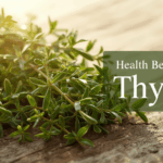 Fresh thyme herbs on a rustic kitchen table with Mediterranean ingredients, representing wellness and health benefits of thyme.